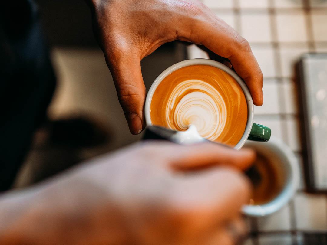 Pouring a cappuccino using the milk frothing capabilities of ones of the best espresso machines under $200