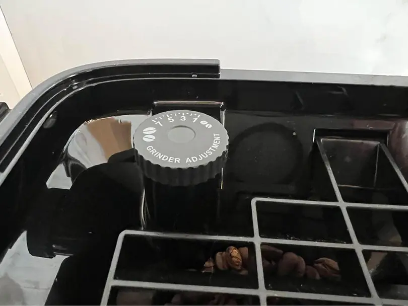 Grind adjustment dial inside the DeLonghi Magnifica Plus' bean hopper