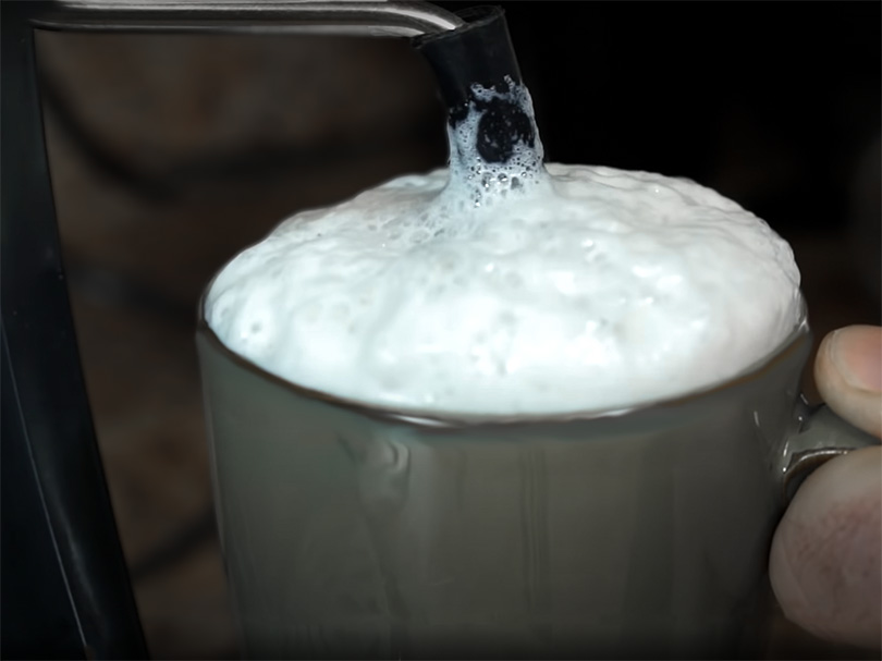 Close up of the milk frother in use on the Capresso 303.01