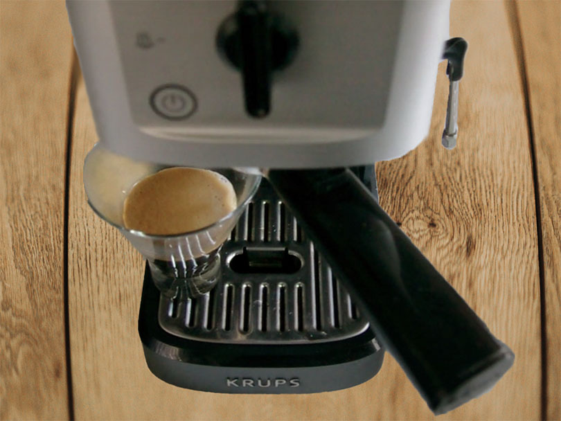 Top down view of the Krups XP344 Calvi making a shot of espresso
