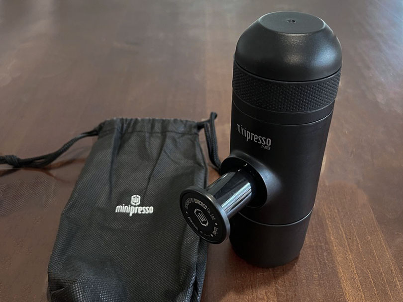 Wacaco Minipresso Review, NS on table beside drawstring bag