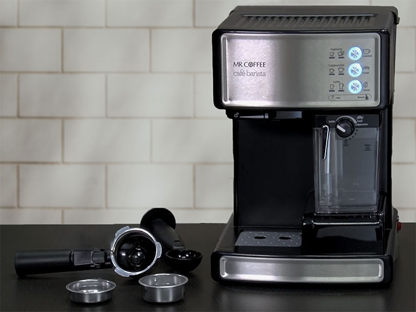 Mr Coffee Cafe Barista with the included portafilter, filter baskets, and plastic tamper