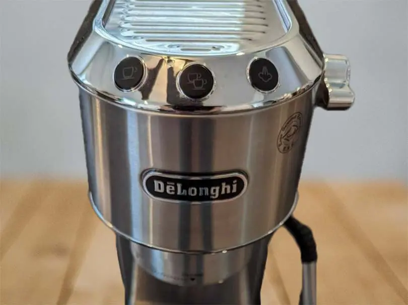 Close-up of the DeLonghi logo on the Dedica Arte