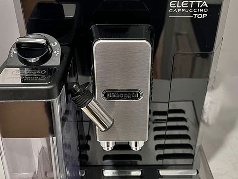 Close up of the DeLonghi logo on one of their espresso machines