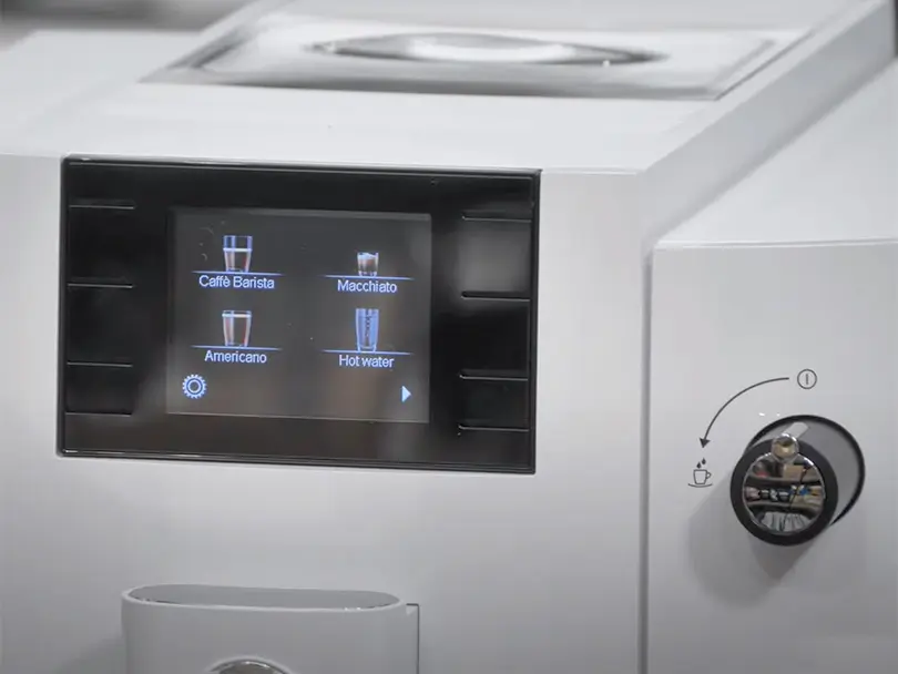 Close up of the color screen and hot water/milk dial on the Jura E6