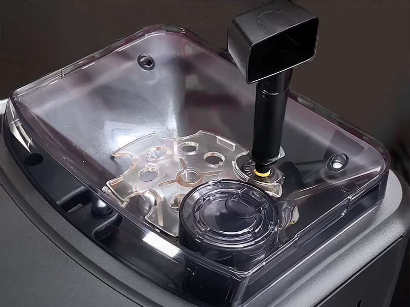 Adjusting the grind settings on the Gaggia Cadorna Prestige with the coffee scoop tool