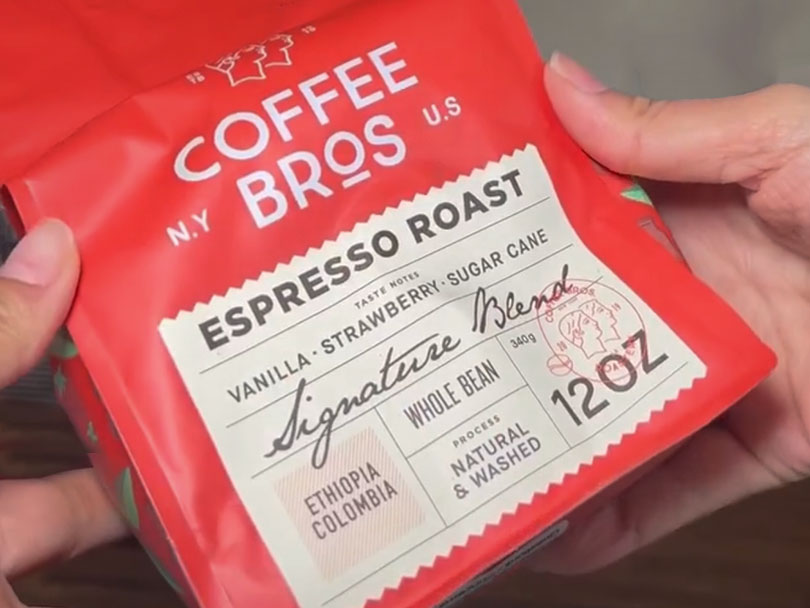 Bag of Coffee Bros Espresso Roast being held towards the camera