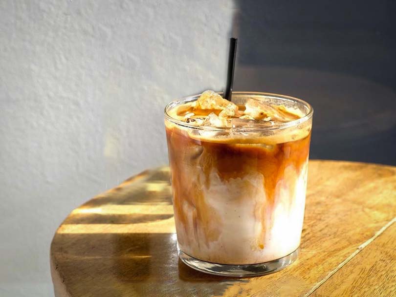 Iced breve coffee with straw