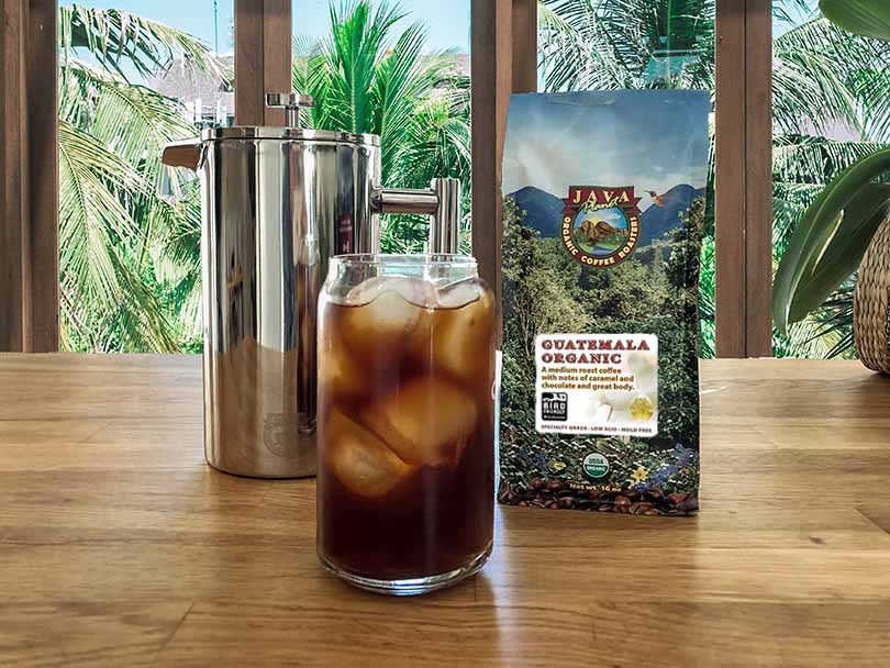 Java Planet - Guatemala Organic - beside a French press and cup of cold brew coffee