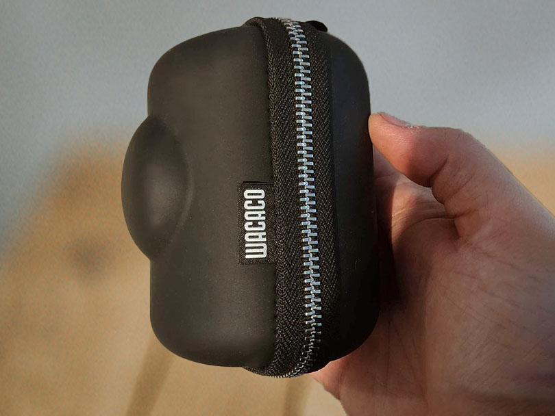 Hand holding the Wacaco Picopresso inside it's protective case