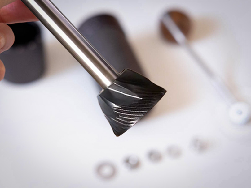 Close-up of the 1Zpresso J Ultra's 48mm titanium coated stainless steel conical burr