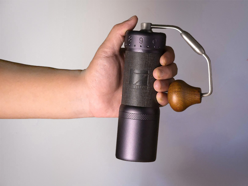 Man's hand holding the 1Zpresso J Ultra