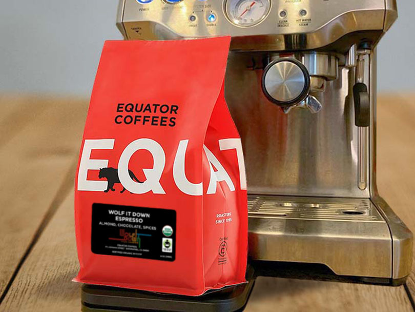 Bag of Equator Coffee Beans in front of espresso machine
