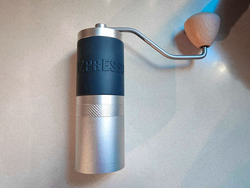 1Zpresso J Manual coffee grinder sat on table