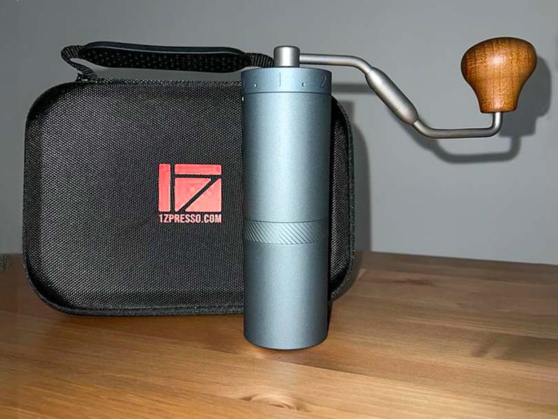 1Zpresso X Ultra standing on wooden table in front of travel case
