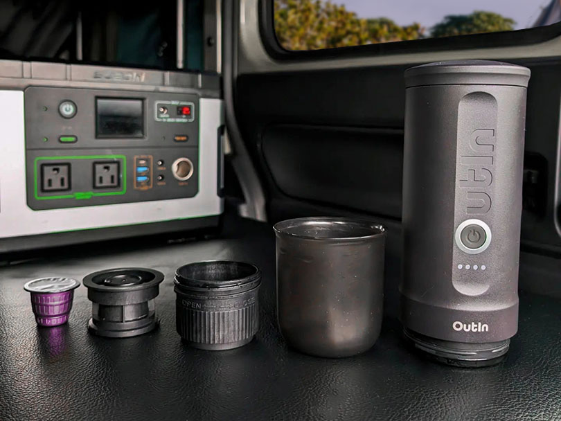 Outin Nano portable espresso machine parts laid out with Nespresso pod