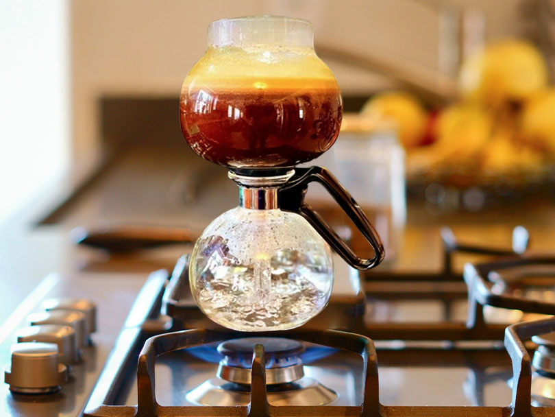 Yama Glass stovetop siphon coffee maker in use