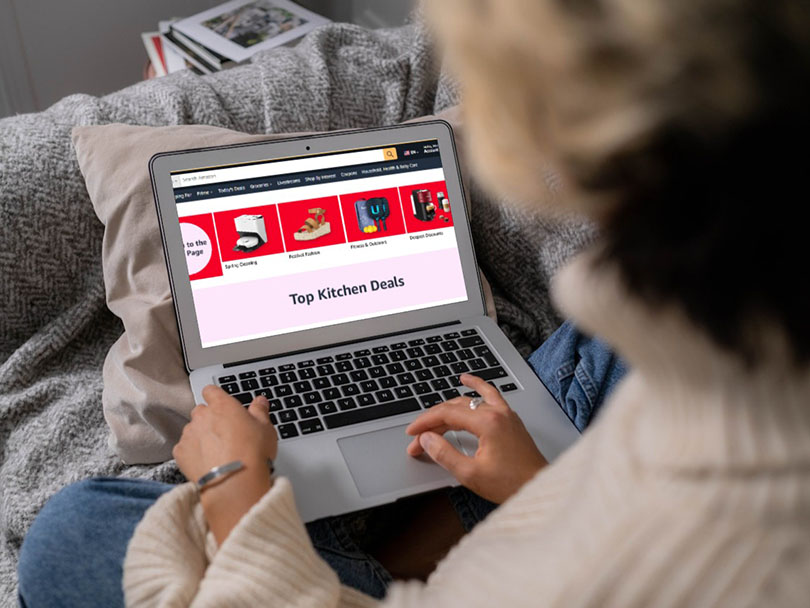 Woman shopping the Amazon Big Spring Sale on her laptop