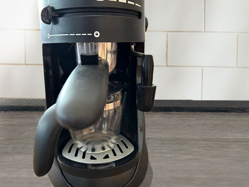 Close up of the Capresso 303.01 Panarello steam wand and carafe