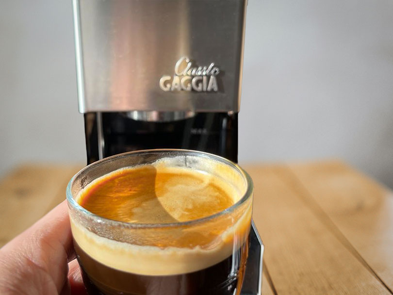 Holding up a freshly made espresso in front of the Gaggia Classic