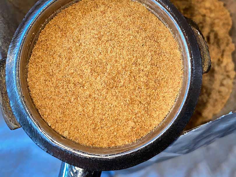 Ground white coffee in a portafilter