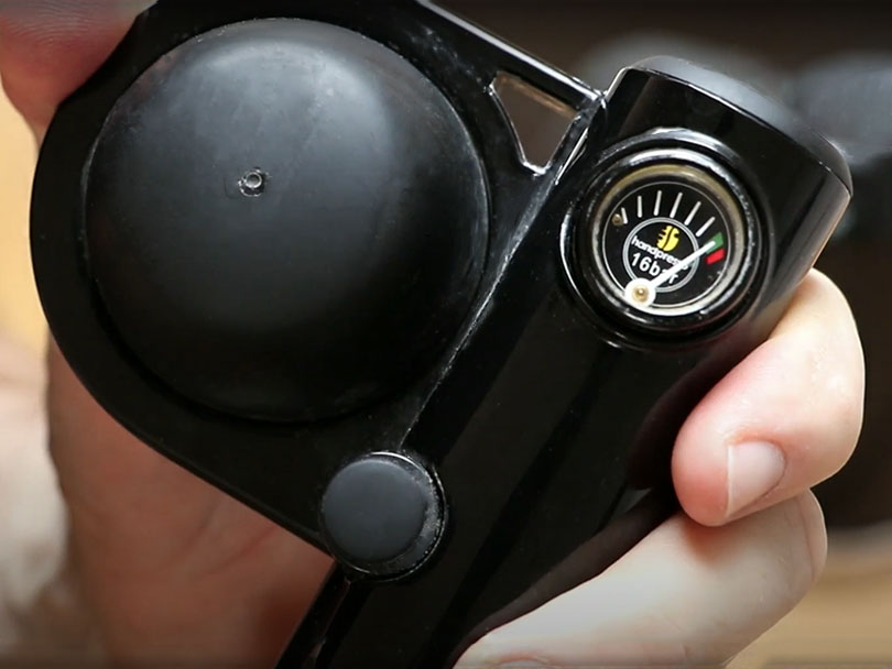 Close-up of the Handpresso Wild Hybrid's pressure gague, hand pumped to the 16 bar green zone