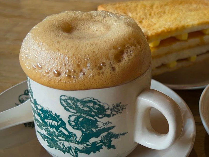 Ipoh white coffee with Kaya toast in the background