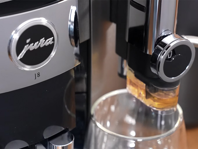Close-up of the Jura J8 branding and syrup attachment