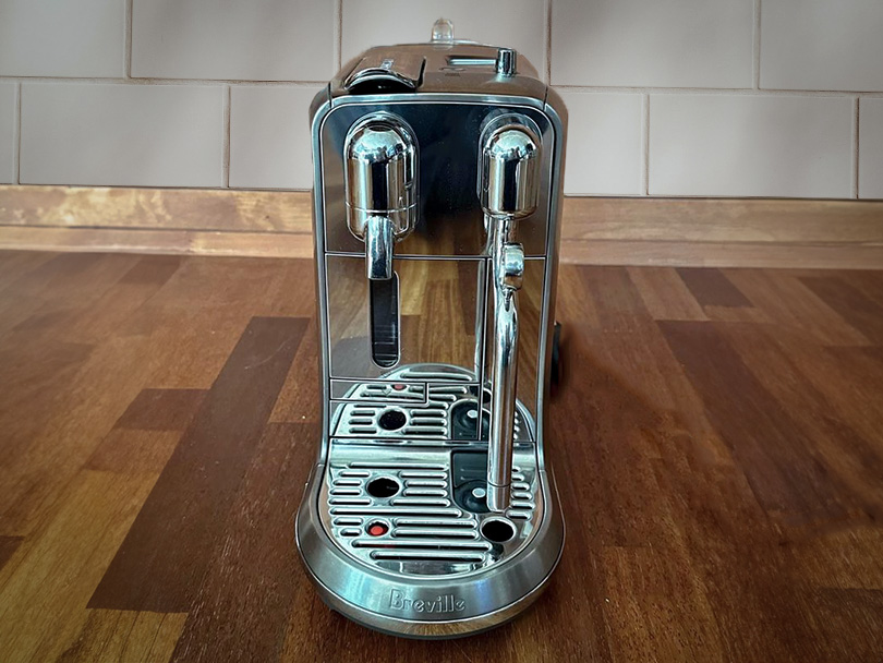 Front view of the Breville Nespresso Creatista Plus on a wooden counter