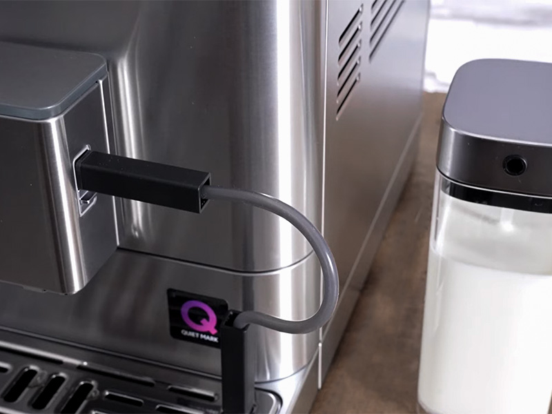 The KF6 has a milk hose that can go into any milk container. The branded KitchenAid one is sitting beside the espresso machine