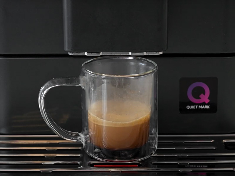 A freshly made shot of espresso sitting on the drip tray of the KitchenAid KF7 espresso machine