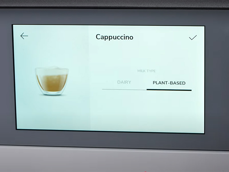 Close up of the touchscreen on the KitchenAid KF8 showing the different milk type options - Dairy or Plant-Based (selected)