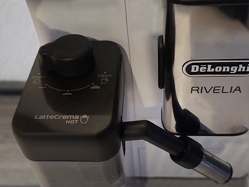 Close-up of the LatteCrema Hot milk dispenser and dial for the Delonghi Rivelia