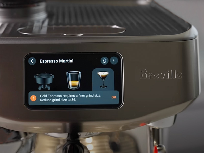 Close-up of the Breville Oracle Jet touchscreen showing 'Espresso Martini' is selection and the on-screen instruction to change the grind size
