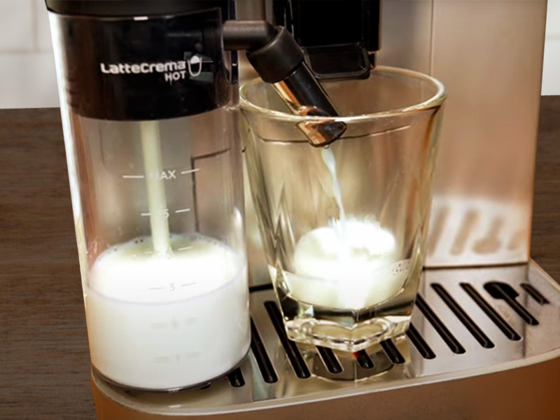 DeLonghi Magnifica Plus - LatteCrema Hot milk system dispensing milk into waiting cup