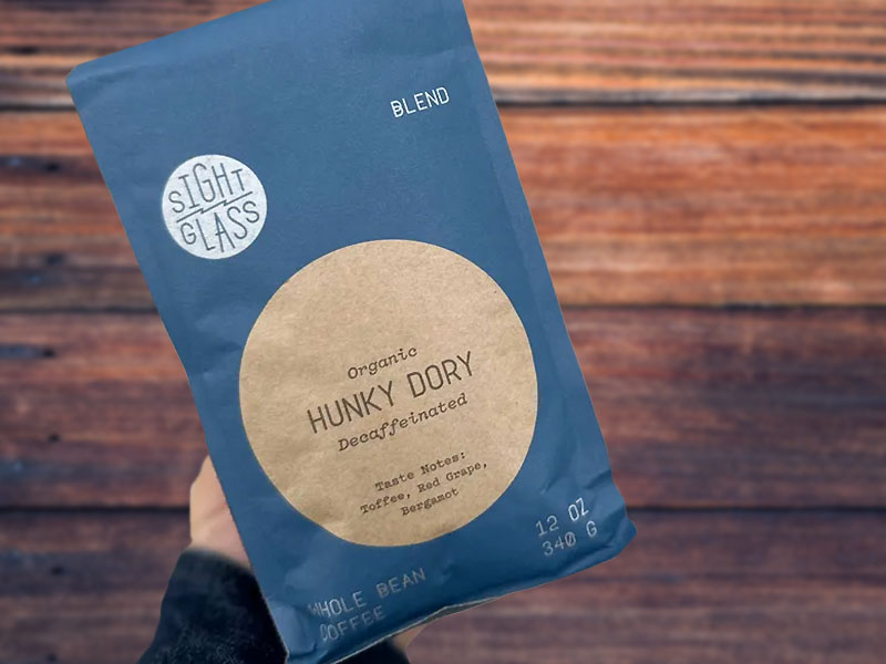 Holding a bag of Sightglass Coffee's Hunky Dory - organic decaf coffee beans