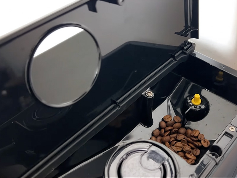 Gaggia Magenta Prestige's bean hopper with whole coffee beans, and the pre-ground chute to the side