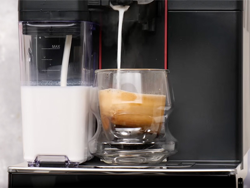 Gaggia Magenta Prestige dispensing hot milk onto an espresso shot