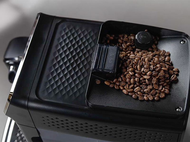 Top-down view of the grinder filled with beans and the adjustment dial for the Philips 3300 espresso machine