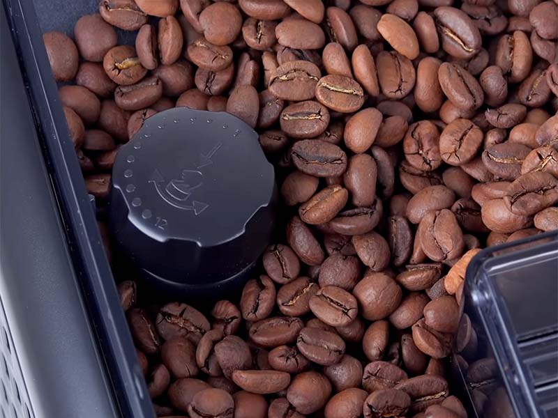 Close up of the 12 step grinder adjustment dial and full bean hopper of the Philips 5500