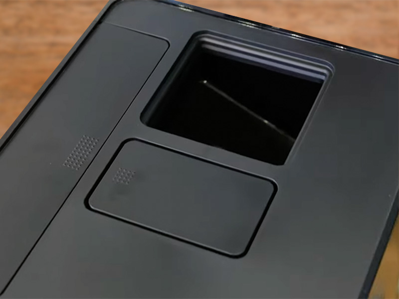 Top down view of the Miele CM 6360 with the bean hopper cover removed. You can see the water tank, pre-ground coffee chute and inside of hopper