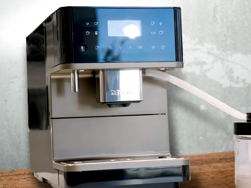 Miele CM 6360 on wooden table, slightly turned away from the camera