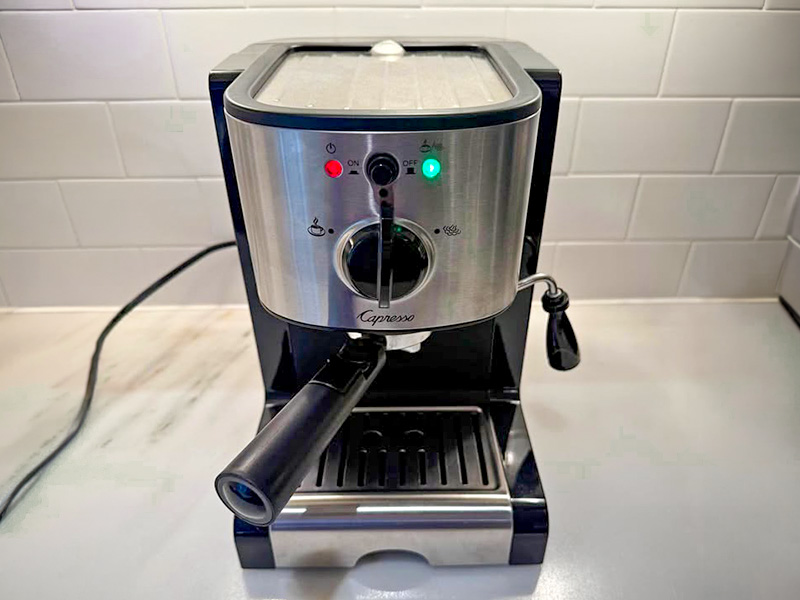 Front view, slightly angled down, of the Capresso EC100 turned on