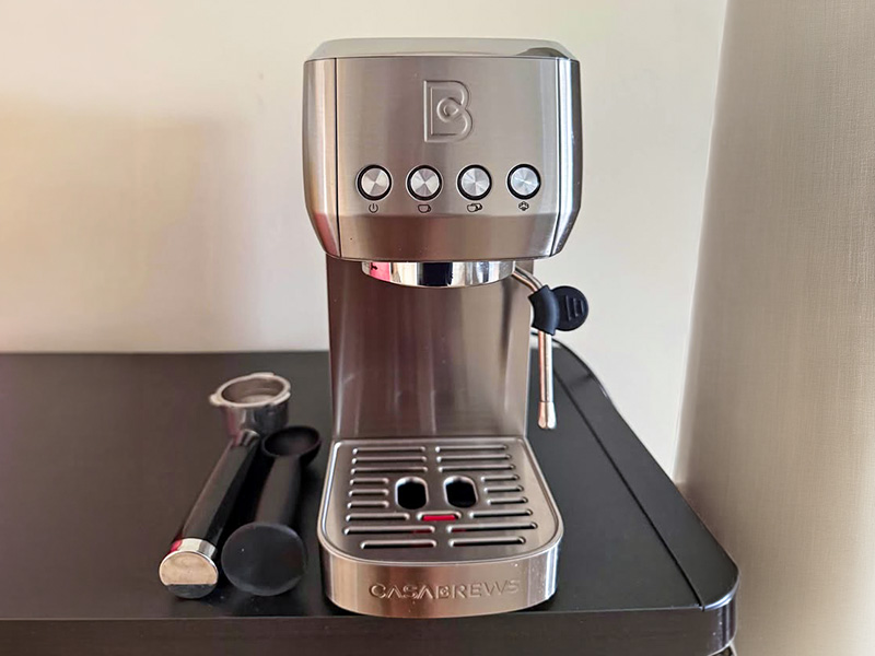 Casabrews 3700 on kitchen bench with portafilter and tamp to the side