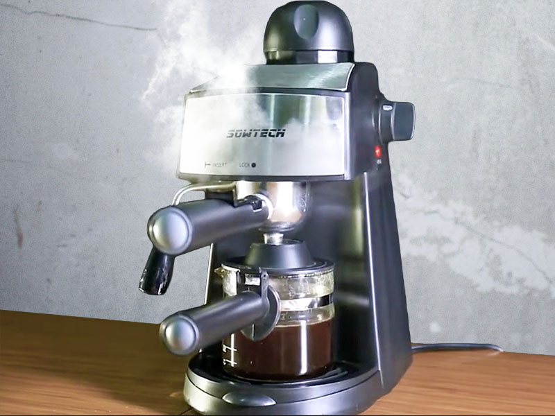 Steam rising up off the Sowtech espresso machine, with 4 cups of coffee in the carafe