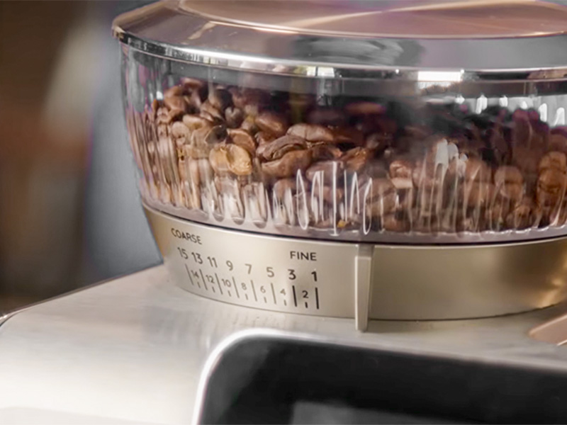 Close-up of the bean hopper and grind adjustment dial on the DeLonghi La Specialista Touch