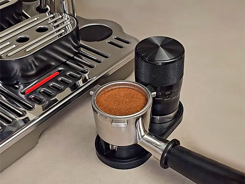 Tamping the freshly ground coffee in the DeLonghi La Specialista Touch's portafilter