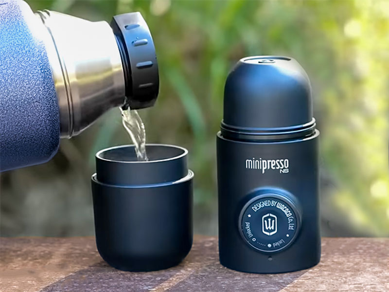 Pouring water from thermos into the small water tank of the Wacaco Minipresso