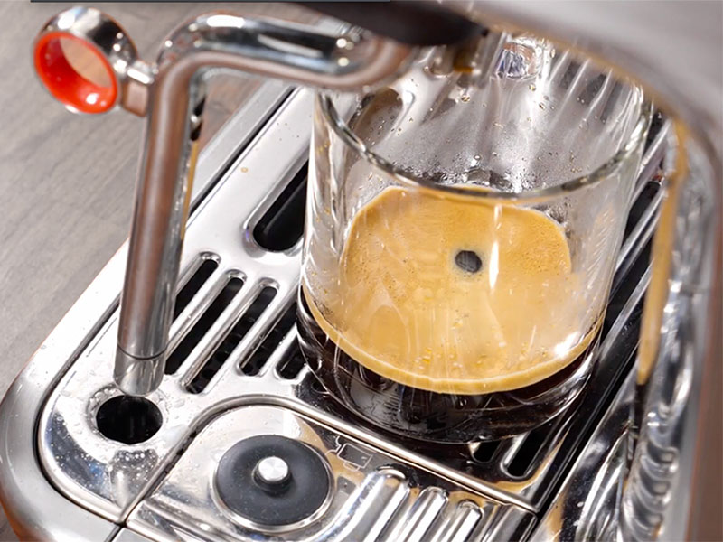 Freshly made Americano sitting on the drip tray of the Breville Barista Touch Impress