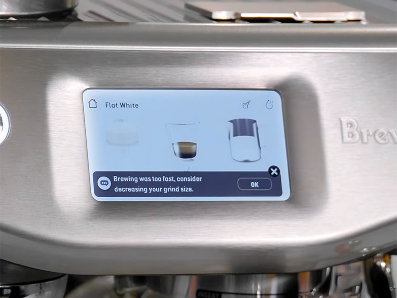 The Barsita Guidance screen of the Breville Barista Touch Impress saying 'brewing was too fast, consider decreasing your grind size' to help with dialling in